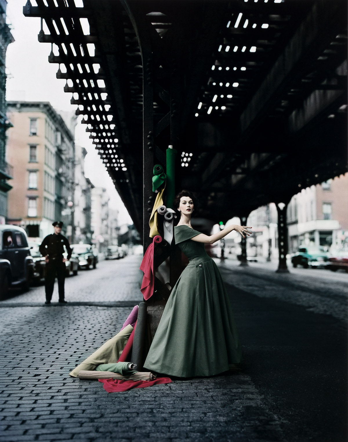 WILLIAM HELBURN (1924- ) Dovima Under the El, Dior Creates Cosmopolitan Drama, Under 3rd Avenue elevated train, New York, NY.